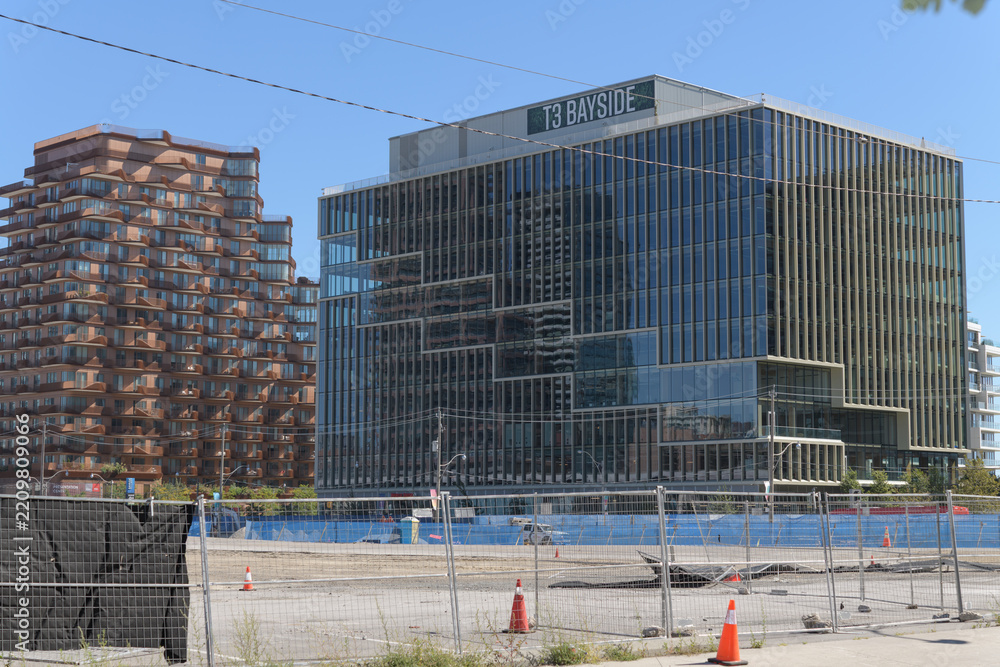 Fototapeta premium distant view of Aqualuna Condos, located at 155 Merchants' Wharf, and T3 Bayside, a corporate office located at 251 Queens Quay E, Toronto