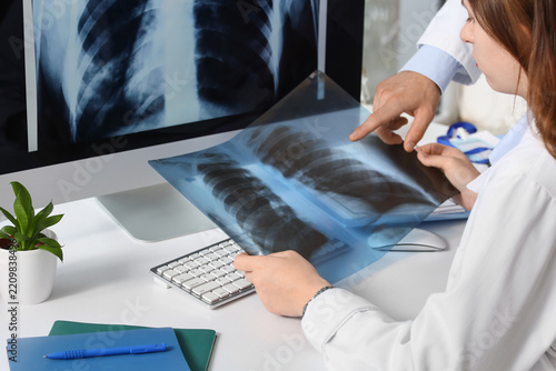Medical diagnosis and lung health, doctors examining chest x-ray film for res...