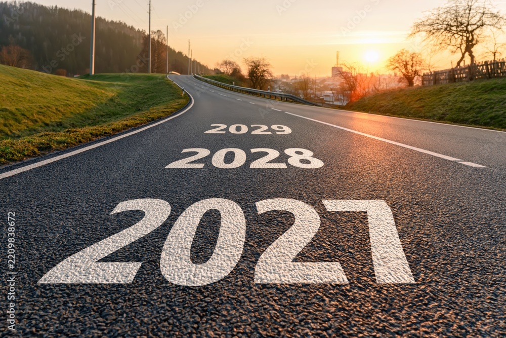 Obraz premium 2027 to 2029 Road with years painted on asphalt leading into a sunset representing future progress and a vision for goal planning