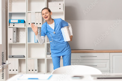 Healthcare career and medical staff, friendly nurse waving hello in hospital ...