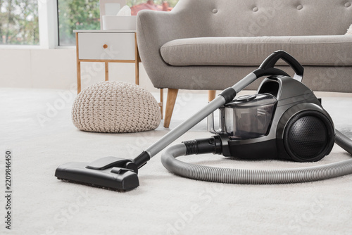 House cleaning and home maintenance, modern vacuum cleaner on carpet in livin...