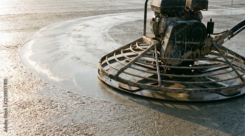 Power float finishing smooth wet concrete floor surface