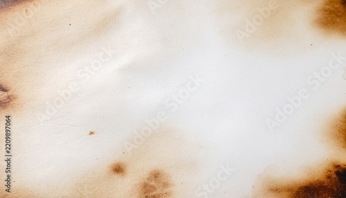 Aged parchment paper with burnt charred edges and vintage texture
