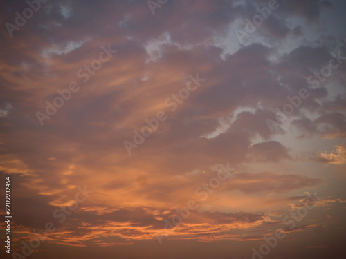 Warm Coral and Orange Sunset Illuminating Delicate Cloud Formations Against a Blue and Lavender Twilight Sky with Dreamy Pastel Colors on West Lake in Hanoi, Vietnam