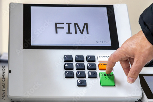 Hand of a person voting on electronic voting machine ahead of Brazilian elections