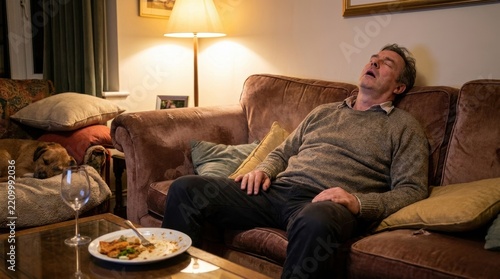 Man Sitting on Couch Feeling Drowsy or Unwell in Living Room at Night
