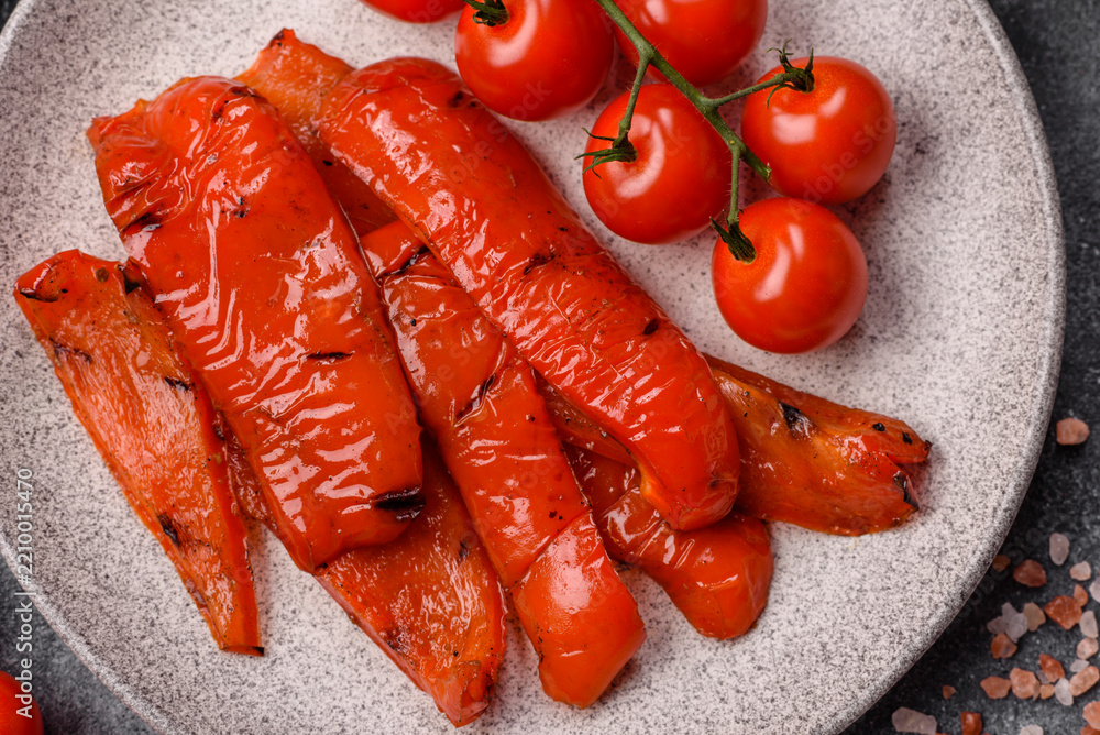 Fototapeta premium Grilled red bell pepper slices seasoned with salt and spices. Grilled sweet pepper