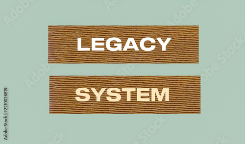 Wooden Texture Conceptual Sign Displaying Legacy System Phrase Representing Outdated Technology or Traditional Software Infrastructure on Gray Background
