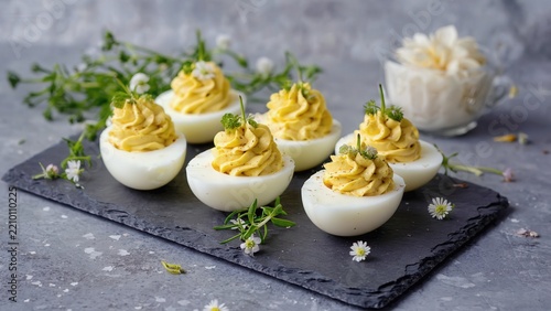 Deviled eggs on slate board with flowers