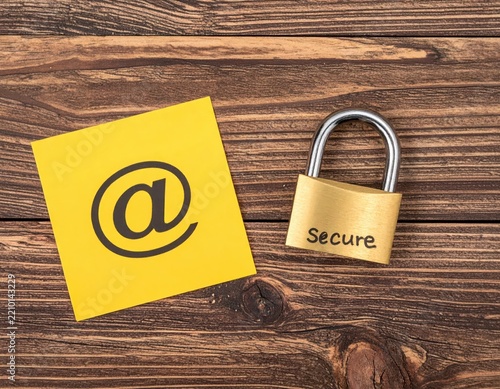 Secure Email Concept with Lock and Yellow Note on Wooden Background