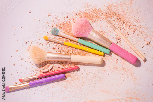 Make up brushes with powder on white background