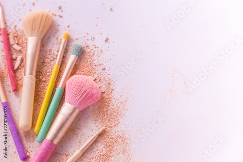 Make up brushes with powder on white background