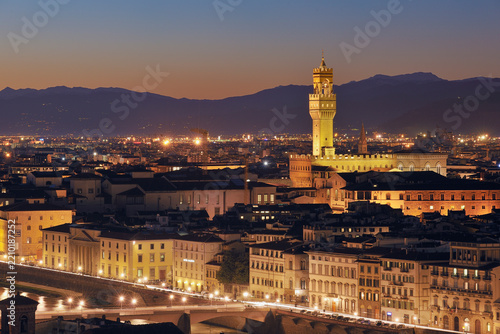 Illuminated Palazzo Vecchio dominates the Florence skyline at dusk