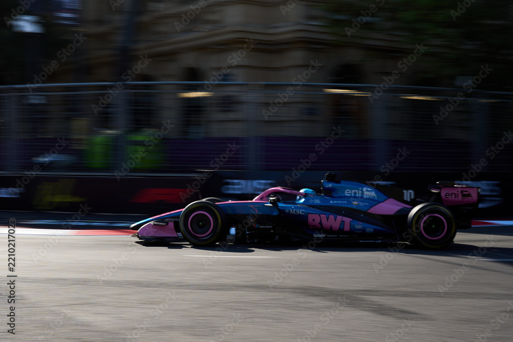 Naklejka premium BAKU, AZERBAIJAN - SEPTEMBER 2026: Pierre Gasly drives the BWT Alpine F1 car at high speed along the Baku City Circuit during Formula 1 Azerbaijan Grand Prix 2026