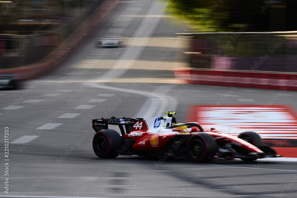 Naklejka premium BAKU, AZERBAIJAN - SEPTEMBER 2026: Lewis Hamilton drives the Scuderia Ferrari F1 car at high speed along Baku City Circuit during Formula 1 Azerbaijan GP 2026