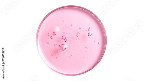 Top-down view of pink liquid with suspended bubbles in round container