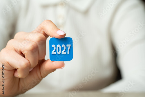 2027 year in the hand of a businesswoman. Business plans and economic forecasts. Strategic vision, market expectations and financial planning. Corporate strategy content, investment and future trend