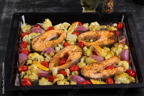 Sheet Pan Salmon and Vegetables on Dark Background. Overhead