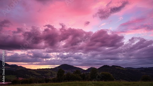 Sunset Timelapse Of Vibrant Pink And Purple Clouds Over Mountain Landscape