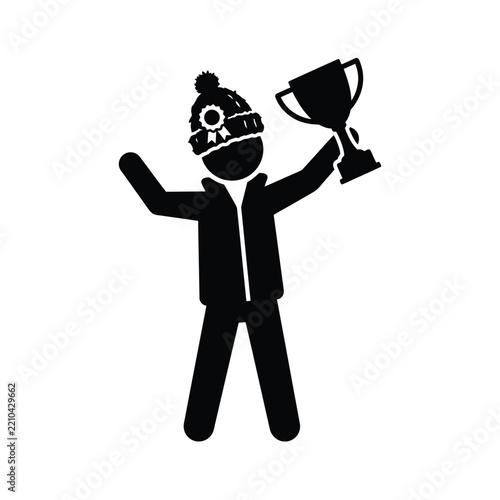 Winner holding trophy wearing winter hat and jacket.