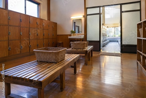 Clean changing room with baskets at a neighborhood Japanese bathhouse