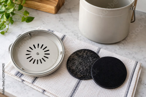 Carbon filter replaced in kitchen compost caddy lid