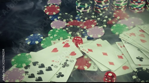 Red Dice and Playing Cards with Casino Chips in Smoke