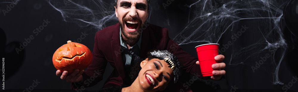 Obraz premium Multicultural couple gather for a lively Halloween party filled with joy, banner 