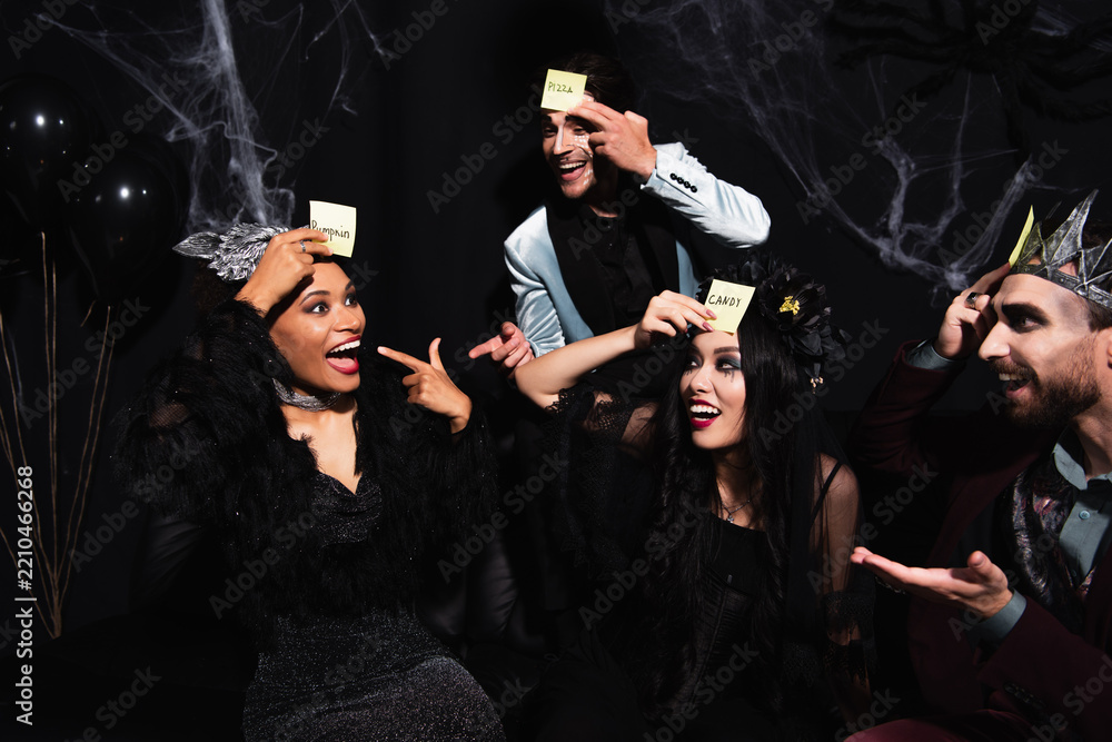 Obraz premium Celebrating Halloween with a diverse group of friends playing guess who game
