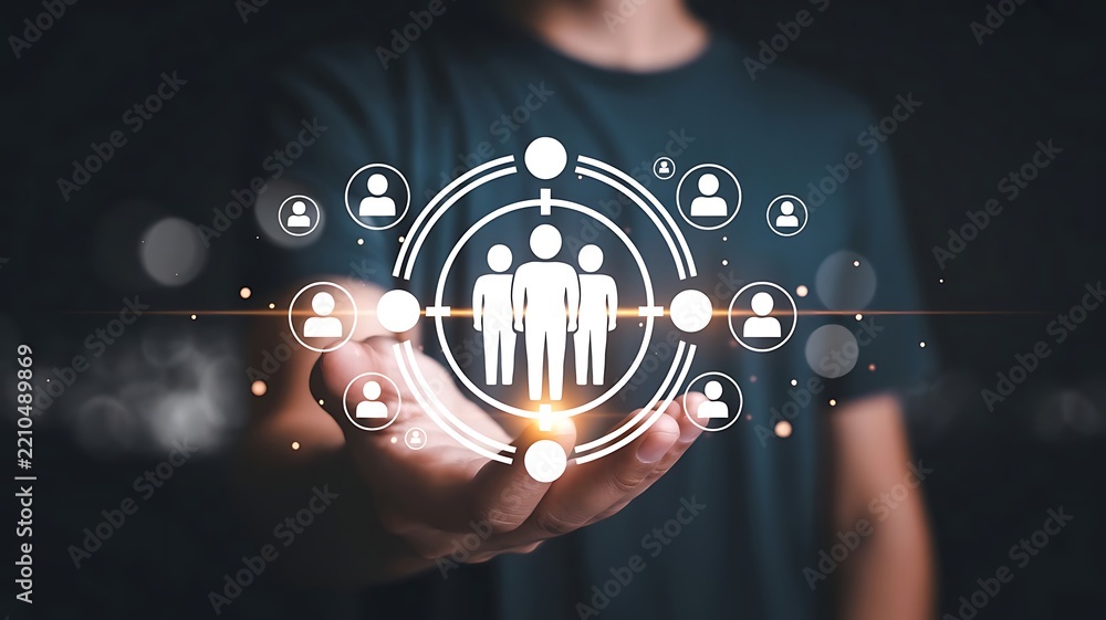 Fototapeta premium Businessman holding digital target icon with human figures representing customer segmentation and market strategy