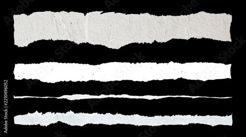 Collection of torn white paper strips with rough edges isolated on black background