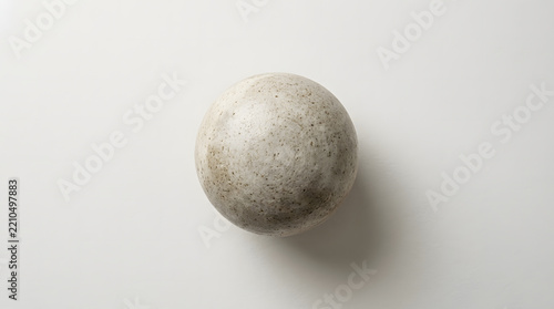A minimalist textured ceramic sphere perfectly centered on a clean white background with a soft and subtle shadow.
