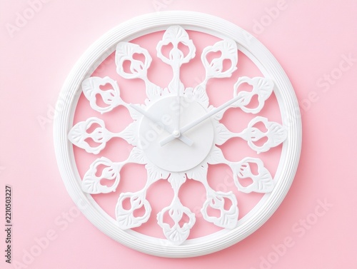 White decorative wall clock on a pink background