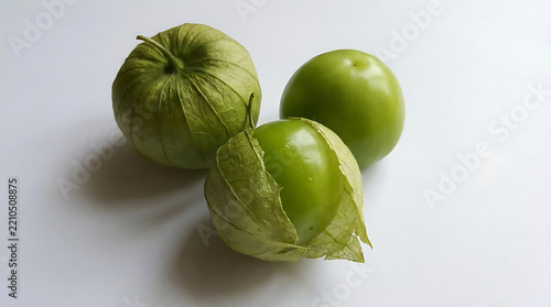 Fresh green tomatillos with husks on white background