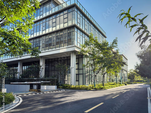 Contemporary Office Building Surrounded by Lush Greenery and Clear Blue Skies
