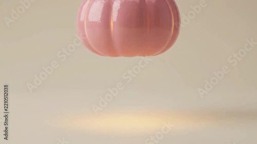 Pink decorative pumpkin glowing and levitating in studio