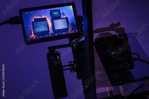 Mirrorless camera rig filmed through teleprompter glass with external monitor