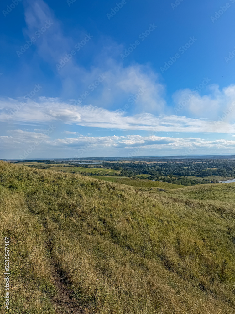 Fototapeta premium Rolling Green Hills and Dramatic Blue Sky in Ukrainian Countryside