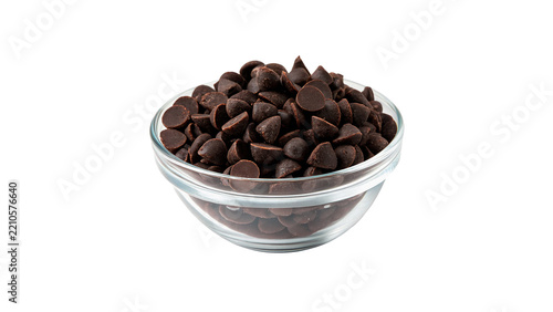 Glass bowl filled with dark chocolate chips drops confectionery isolated on transparent background