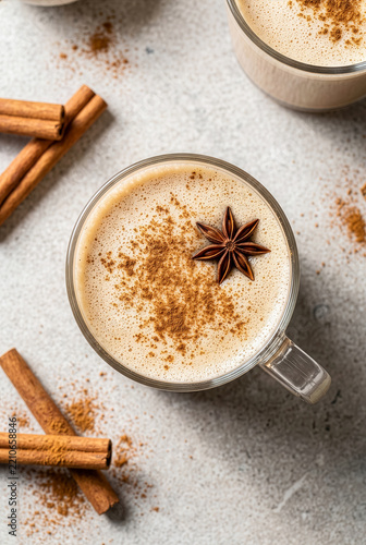 Hot masala chai tea latte with cinnamon powder and star anise top view