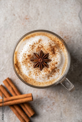 Hot chai tea latte with thick foam cinnamon powder and star anise top view