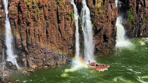 Iguazu Falls, Brazil, tourist boat cruising near massive waterfalls and rocky cliffs