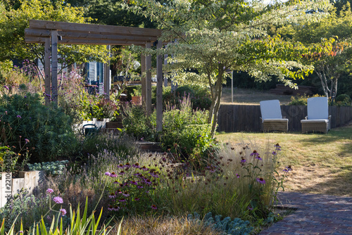Garden with mixed planting and loungers