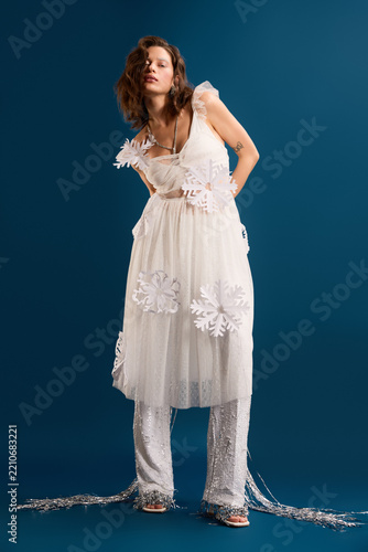 Obraz na plátně Charming winter aesthetic with a young woman in a glam holiday outfit