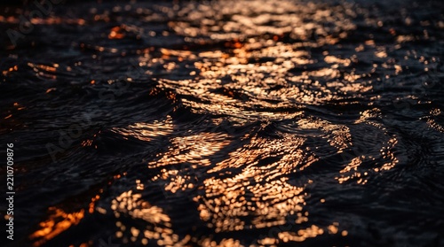 Golden sunlight reflects vibrantly on rippling water, creating a dramatic contrast and serene mood