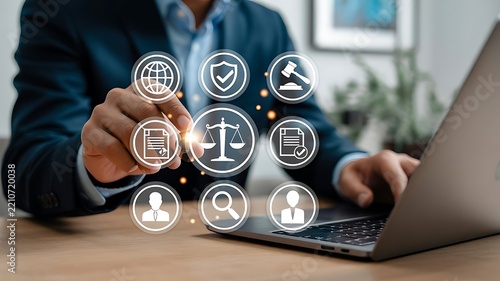 Professional businessman using laptop with digital law and justice icons for legal technology and corporate consulting services