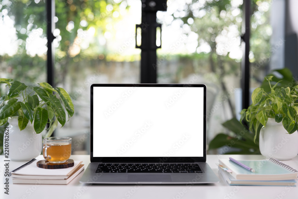 Obraz premium Laptop and a glass of tea and notebook, cozy indoor workspace