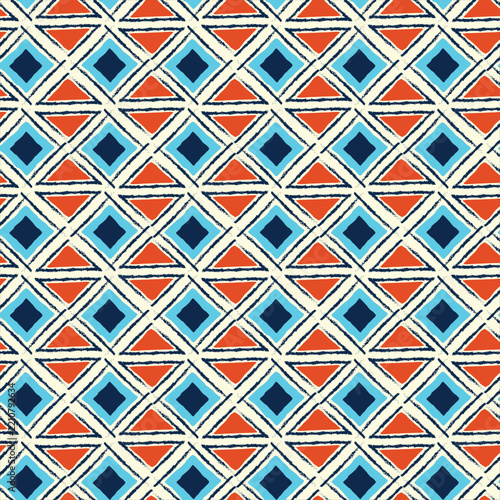 Vibrant geometric pattern featuring blue and orange diamonds on a light background.