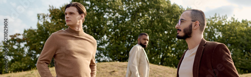 Elegant autumn fashion among diverse friends in a rustic landscape, banner 