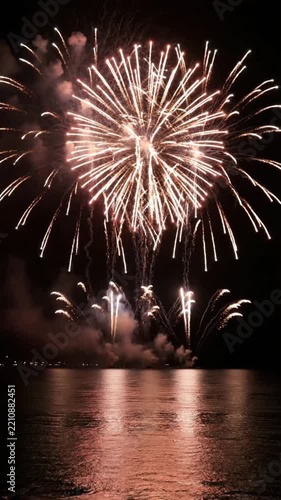 Fireworks light up the night sky over the water during a festive celebration at the beach